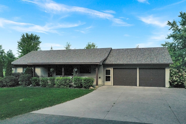 ranch-style home featuring a garage and a front yard