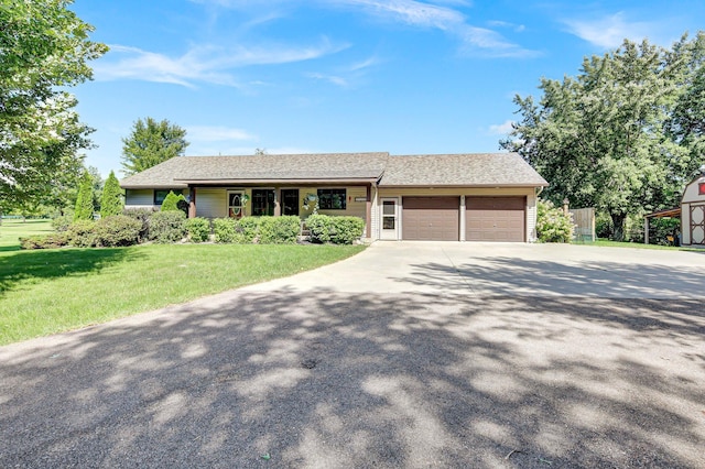 single story home with a garage and a front yard