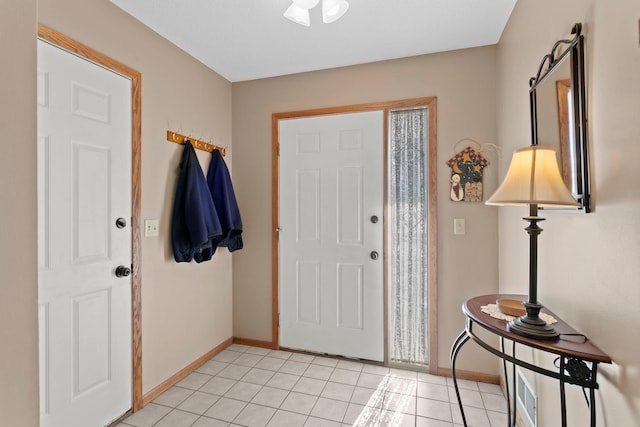 entryway featuring baseboards and light tile patterned flooring