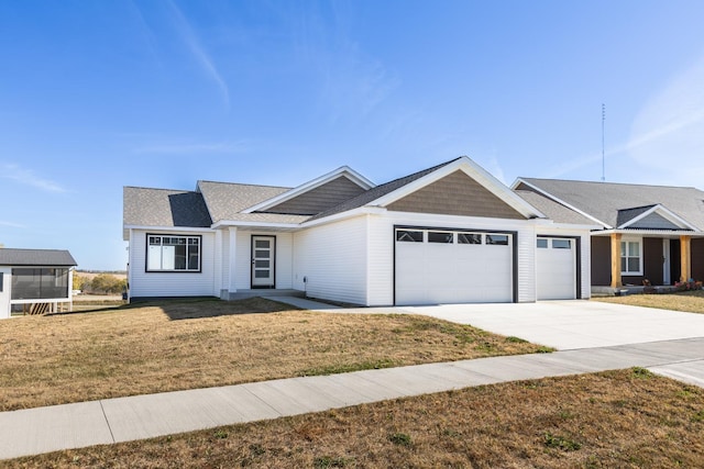 single story home featuring a garage and a front lawn