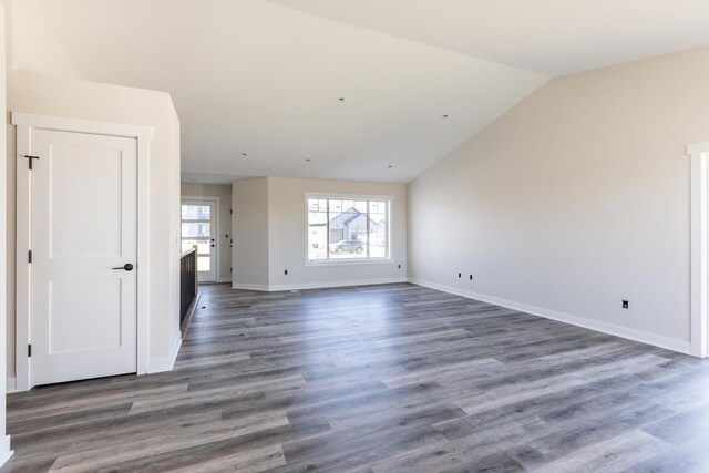 1705 Brandt Dr NE, Byron, MN 55920 - unfurnished living room featuring dark hardwood / wood-style flooring and vaulted ceiling