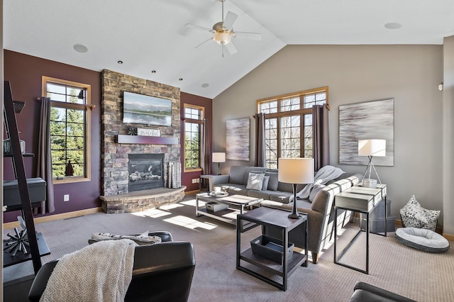 carpeted living area featuring high vaulted ceiling, a fireplace, a ceiling fan, and baseboards