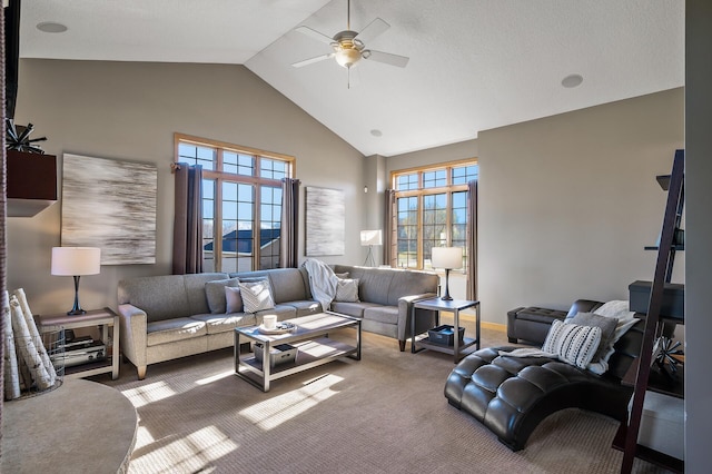 living area with a ceiling fan, carpet, high vaulted ceiling, and baseboards