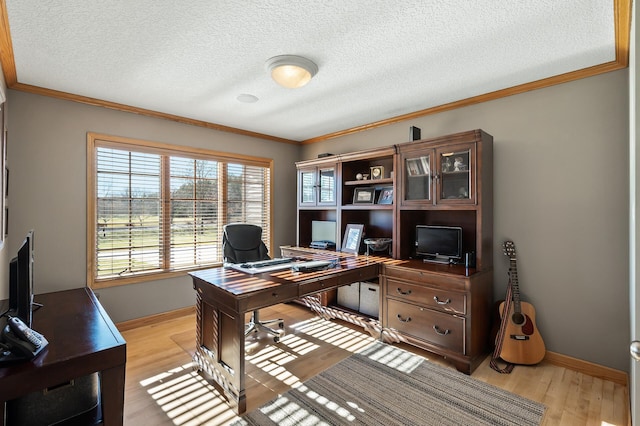 office area with baseboards, light wood finished floors, a textured ceiling, and crown molding