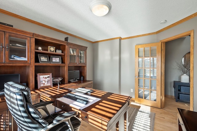 office area with ornamental molding, light wood-type flooring, a textured ceiling, and baseboards