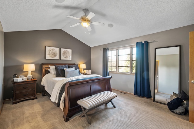 bedroom featuring light carpet, a textured ceiling, vaulted ceiling, and a ceiling fan