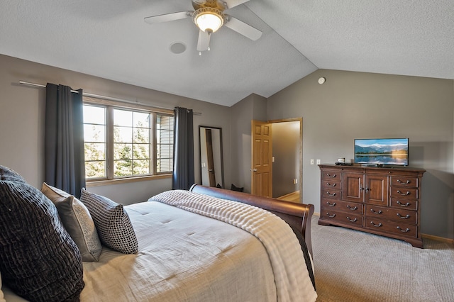 carpeted bedroom featuring a ceiling fan, lofted ceiling, and a textured ceiling