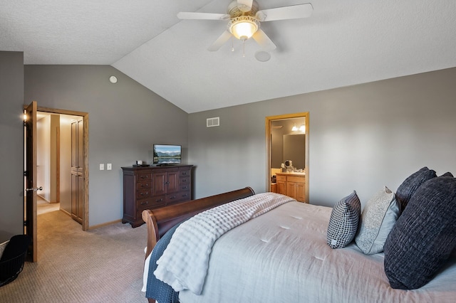 bedroom with baseboards, visible vents, light colored carpet, ceiling fan, and vaulted ceiling