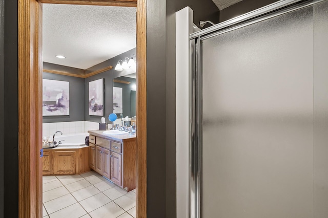 full bathroom with a garden tub, tile patterned flooring, a textured ceiling, vanity, and a shower stall