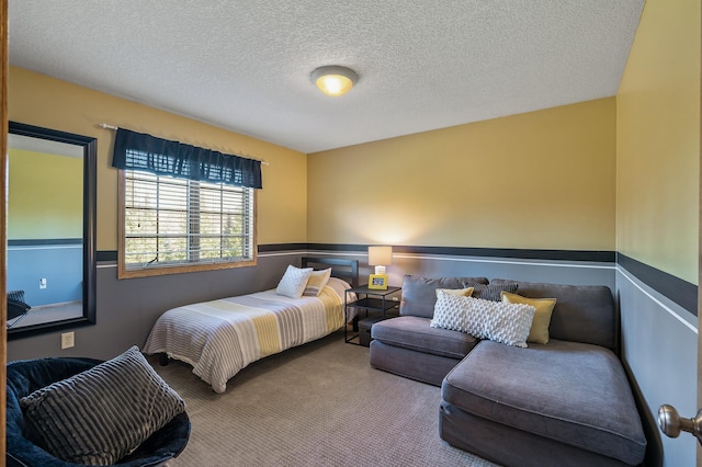 bedroom featuring a textured ceiling and carpet floors