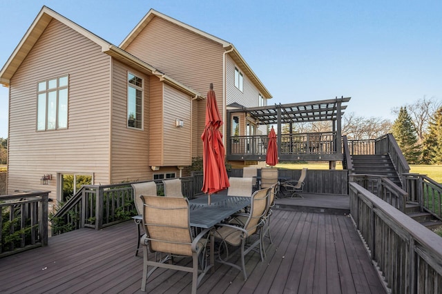 wooden terrace with outdoor dining area and a pergola