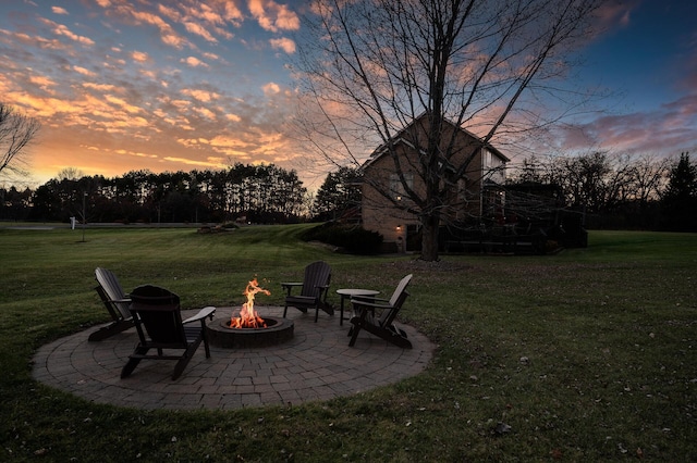 yard at dusk with a fire pit and a patio