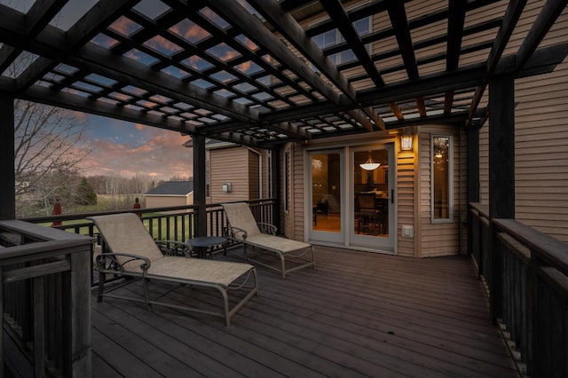 deck at dusk featuring a pergola