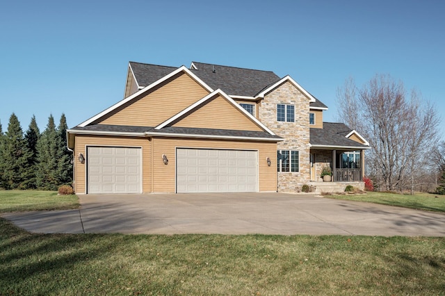 view of front of home with covered porch, an attached garage, stone siding, driveway, and a front lawn