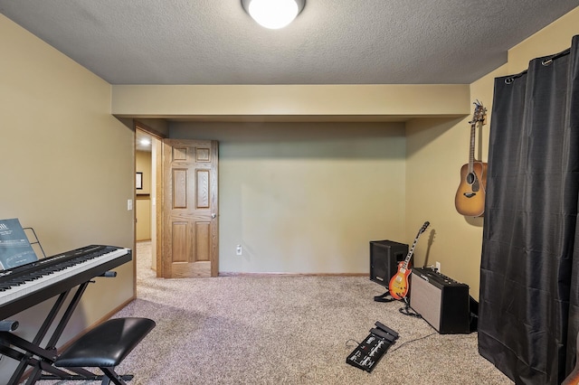 interior space featuring a textured ceiling, carpet flooring, and baseboards