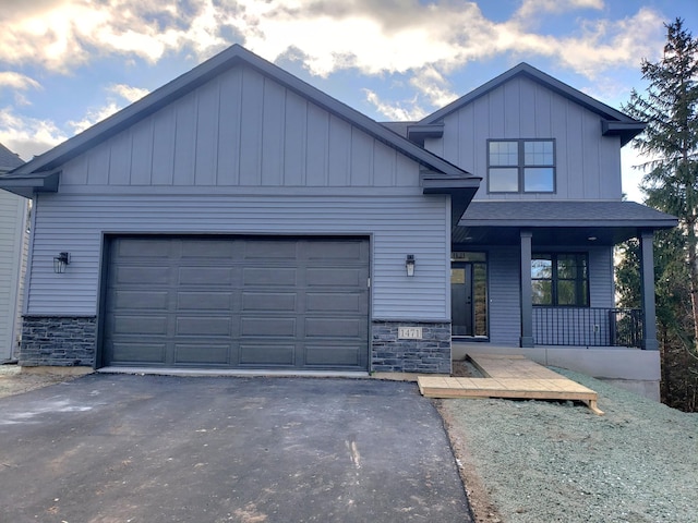 view of front of house featuring a garage and a porch