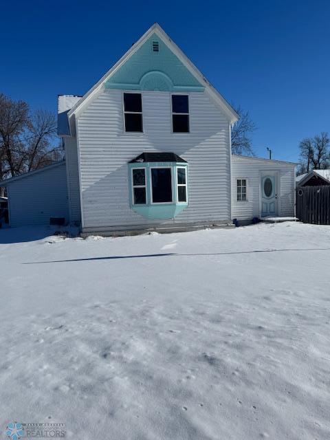 view of snow covered rear of property