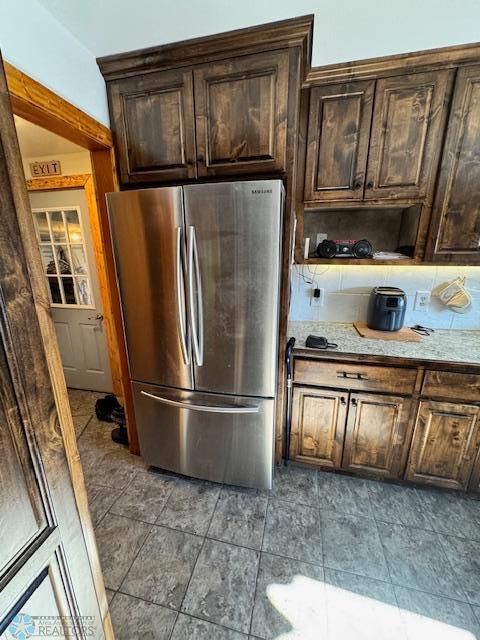 kitchen with stainless steel refrigerator and dark brown cabinets