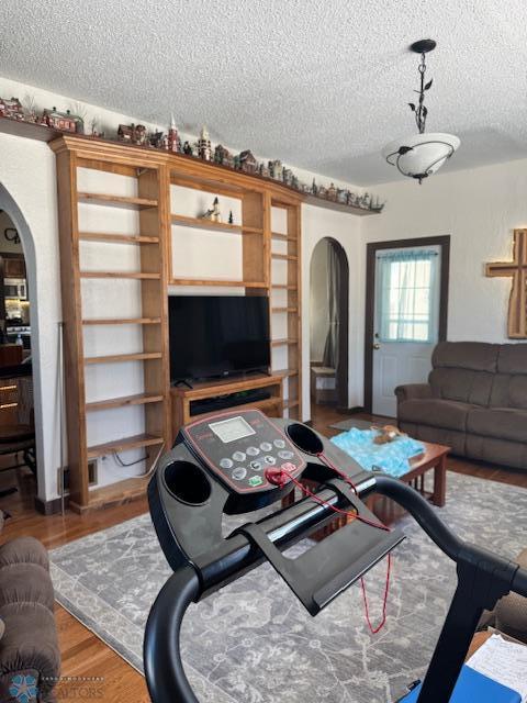 living room with hardwood / wood-style floors and a textured ceiling