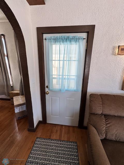 doorway with hardwood / wood-style flooring