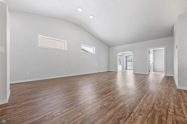 unfurnished living room featuring dark wood-type flooring and vaulted ceiling