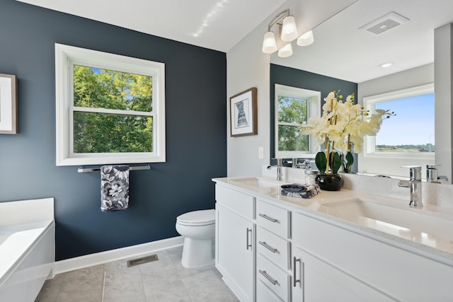 bathroom with vanity, tile patterned floors, and toilet