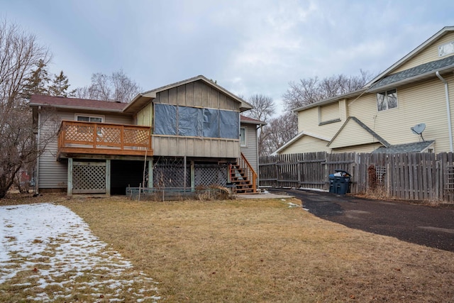 back of house with a lawn and a deck