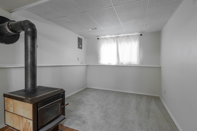 unfurnished living room with a paneled ceiling and carpet flooring