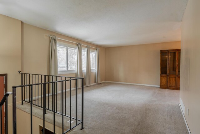 unfurnished room featuring light colored carpet