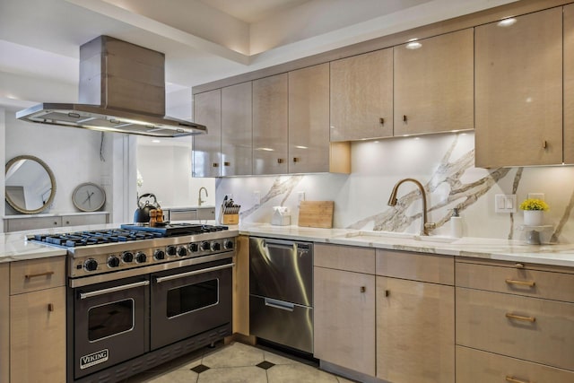 kitchen with sink, island range hood, light brown cabinets, appliances with stainless steel finishes, and light stone countertops