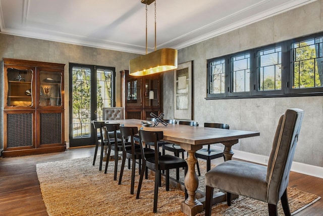 dining room with crown molding, dark hardwood / wood-style flooring, and french doors