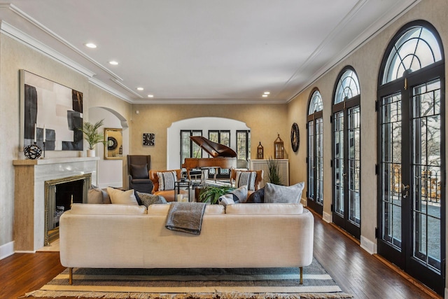 living room featuring crown molding, plenty of natural light, and dark hardwood / wood-style flooring