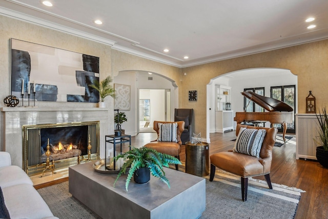 living room featuring crown molding, dark wood-type flooring, and a high end fireplace