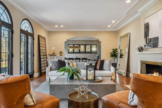 living room featuring hardwood / wood-style flooring and crown molding