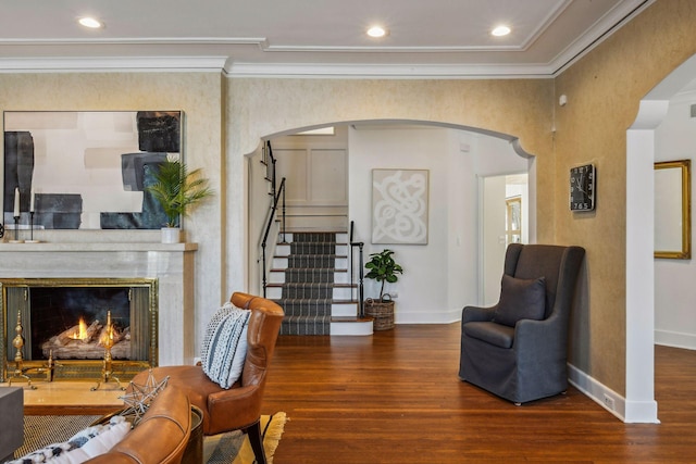 living area featuring ornamental molding and dark hardwood / wood-style flooring