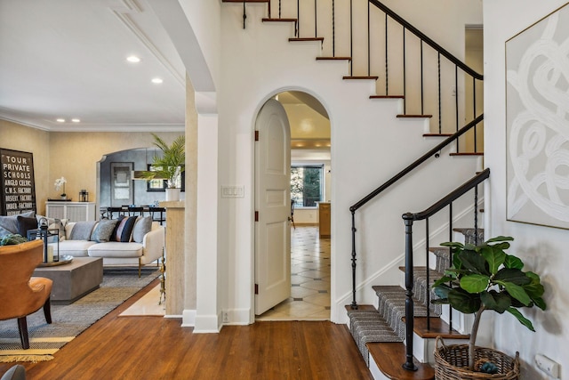 entrance foyer with wood-type flooring and ornamental molding