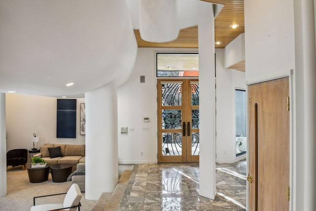 entryway with a towering ceiling, wood ceiling, and french doors