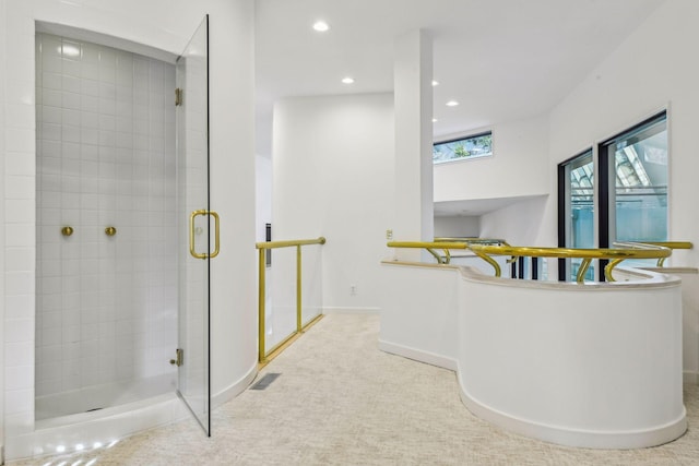 bathroom featuring a shower with door