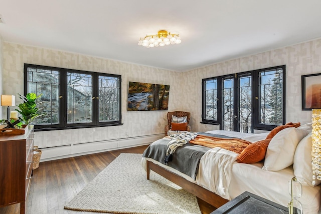 bedroom with dark hardwood / wood-style flooring and a baseboard radiator