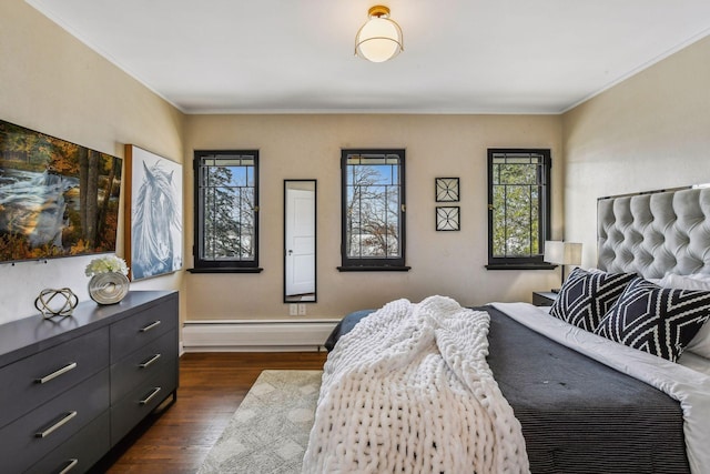 bedroom featuring ornamental molding, a baseboard heating unit, and dark wood-type flooring