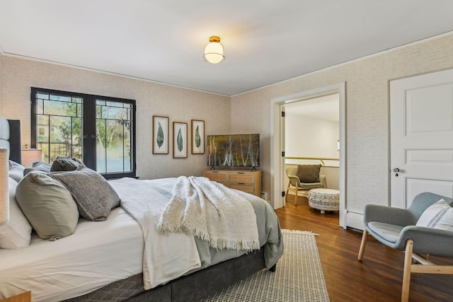 bedroom featuring dark wood-type flooring, baseboard heating, and french doors