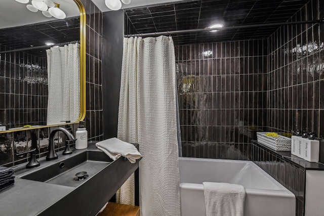 bathroom featuring shower / bathtub combination with curtain and sink