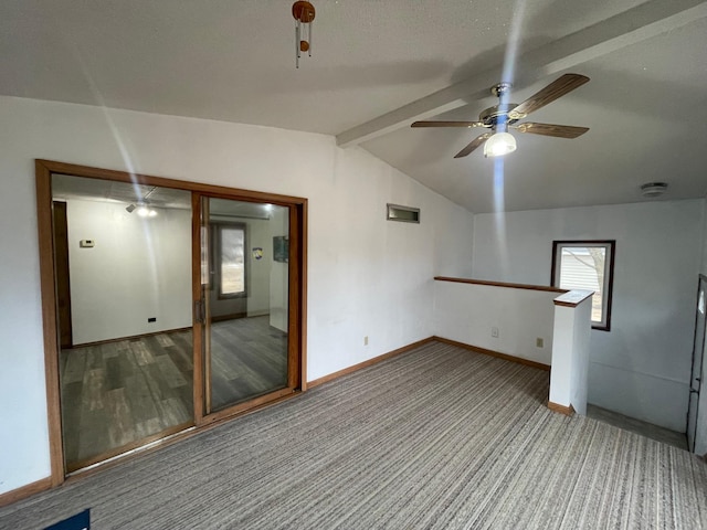 unfurnished room with a ceiling fan, light carpet, lofted ceiling with beams, and baseboards