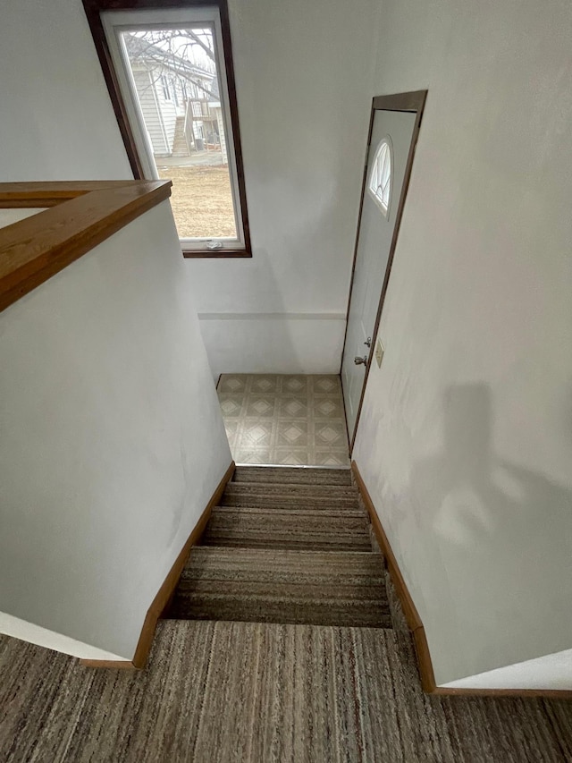 stairs featuring baseboards