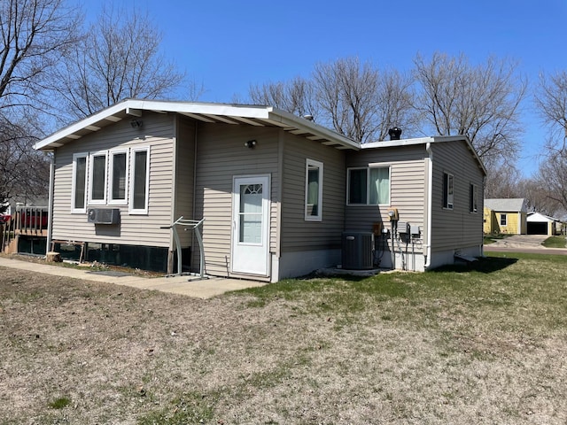 1920 Spruce Ave, Worthington, MN 56187 - rear view of property featuring cooling unit and a lawn