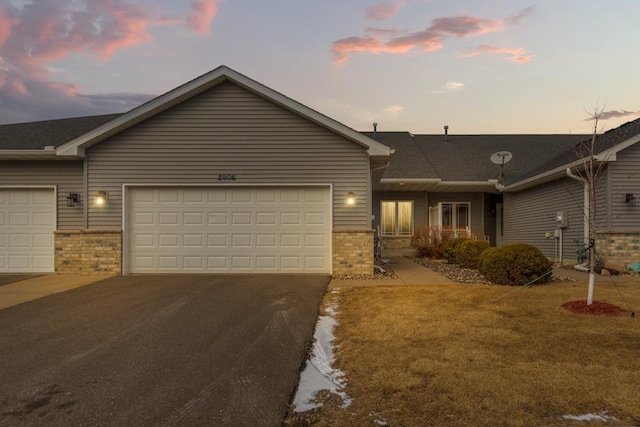 single story home with a yard and a garage