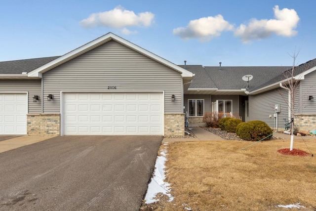 single story home featuring a garage and a front yard