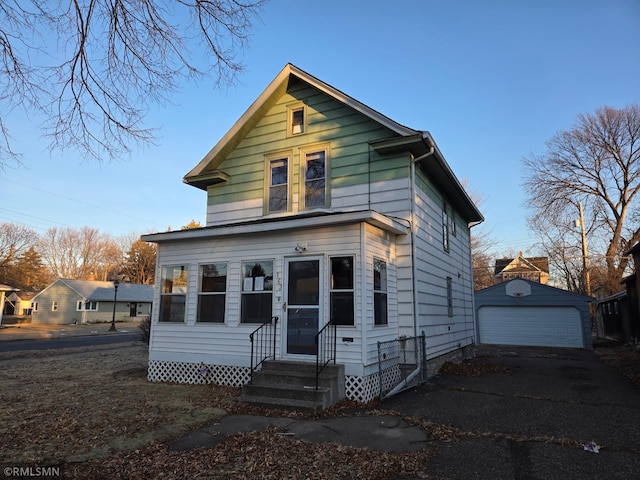 view of front of property with a garage and an outdoor structure