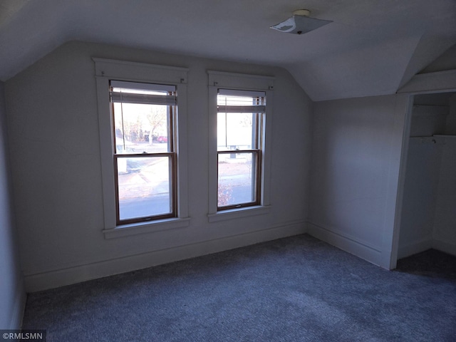 bonus room with carpet floors and vaulted ceiling