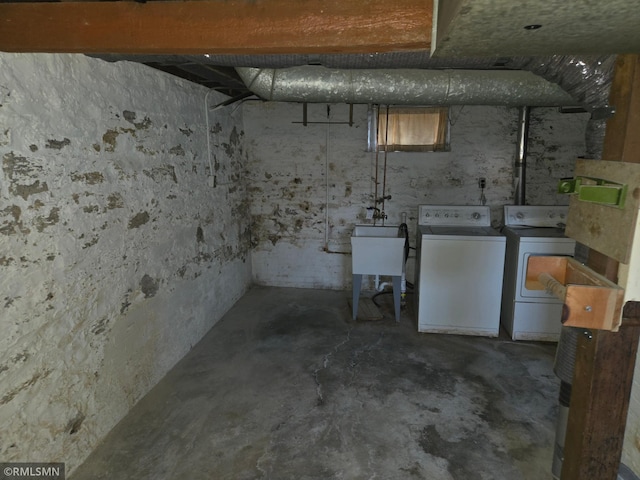 basement with sink and washer and clothes dryer